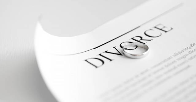 Divorce document with a wedding ring sitting on the document
